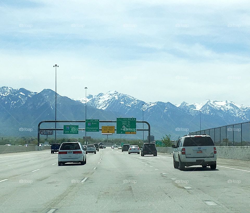 Driving into the mountains that surround Salt Lake City in Utah, USA.  The highways are wide and the mountains are still snow capped in May. 