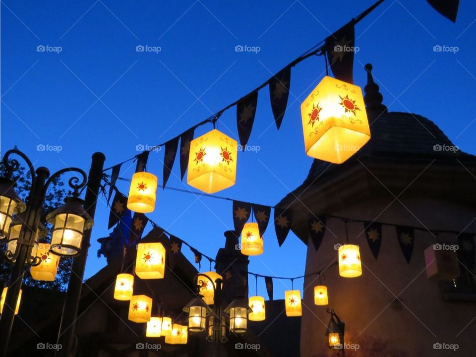 Golden lanterns hanging just after sundown with blue sky background 