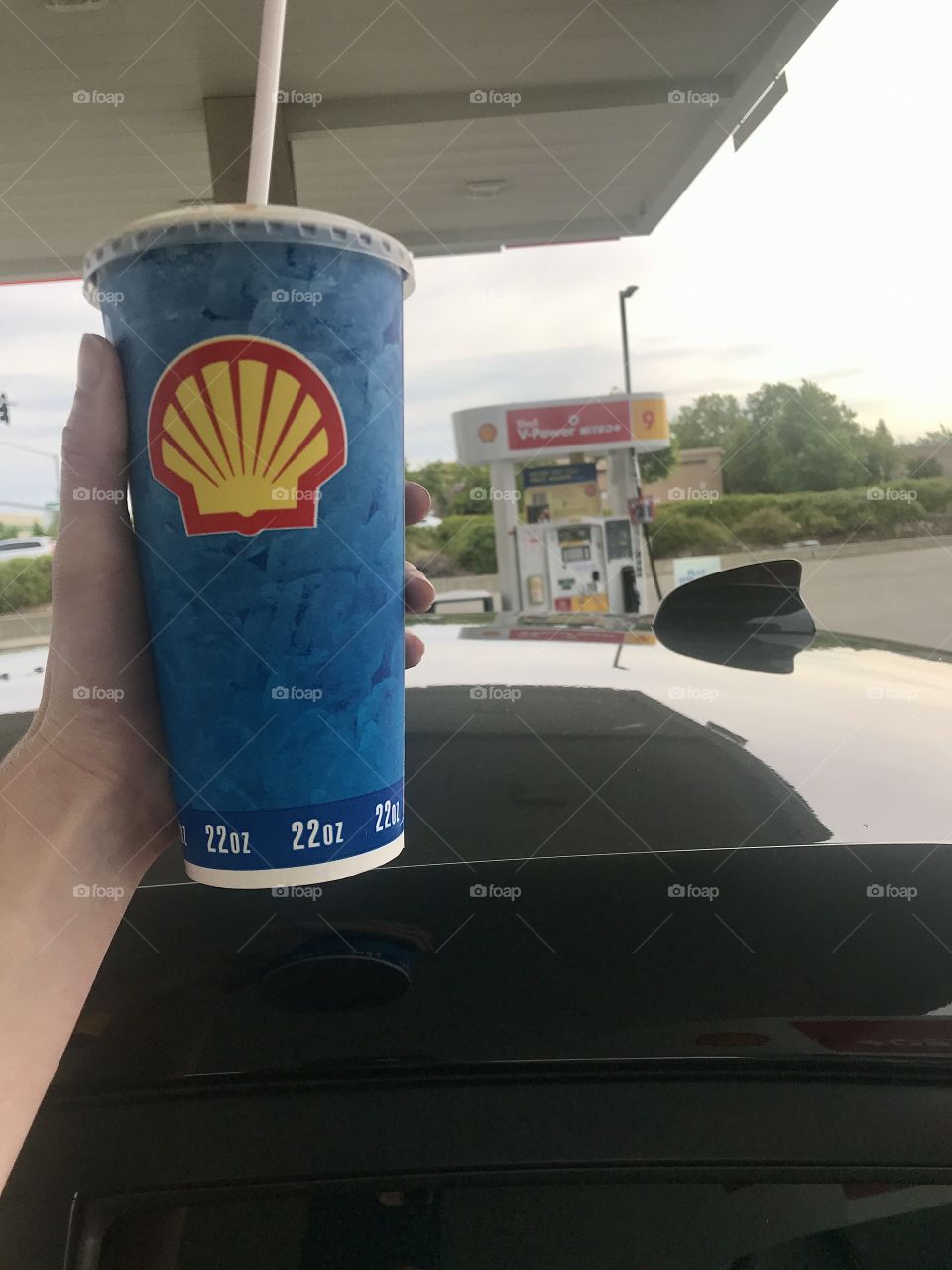 Holding up a soft drink from the Shell gas station