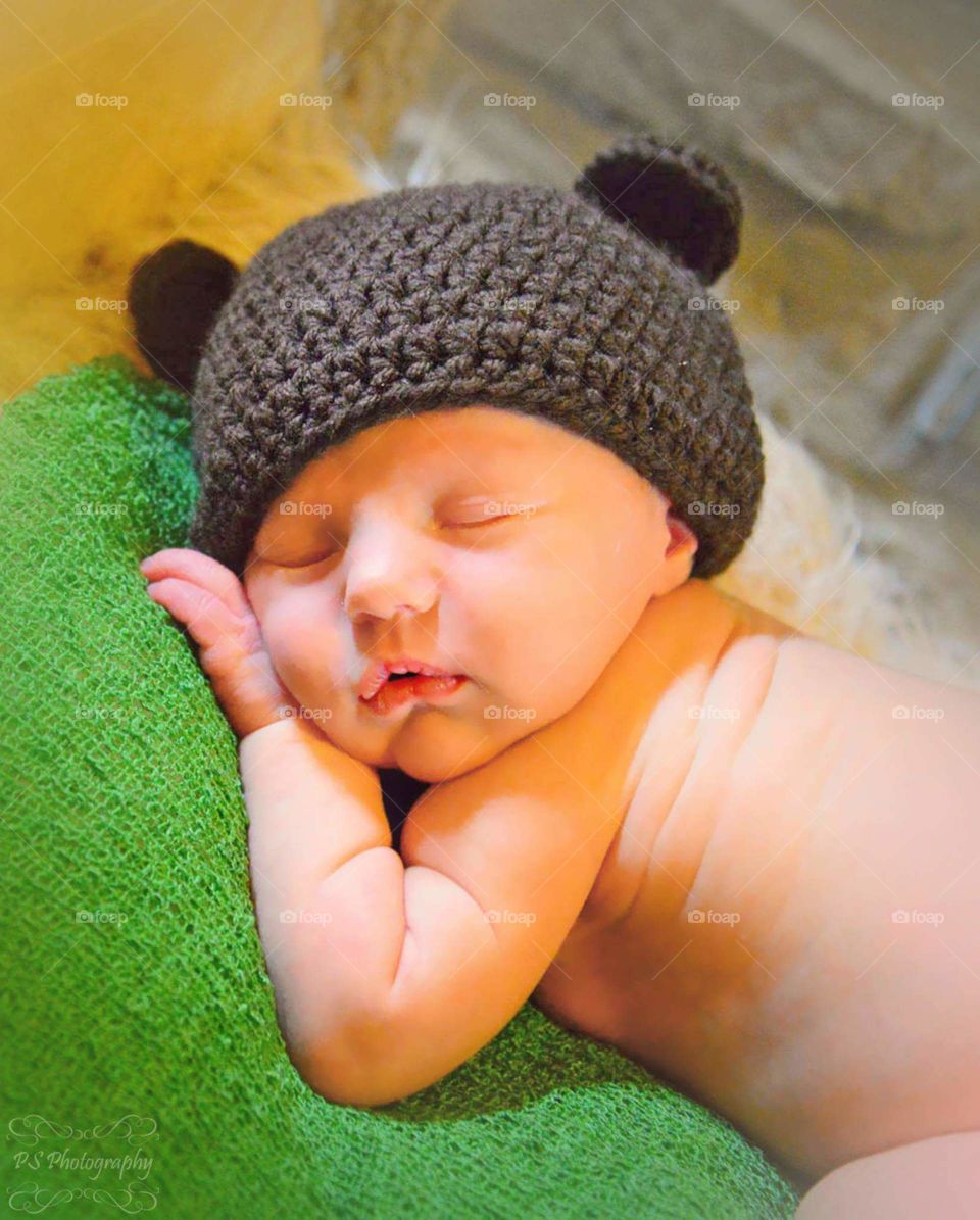 Newborn with teddy bear cap