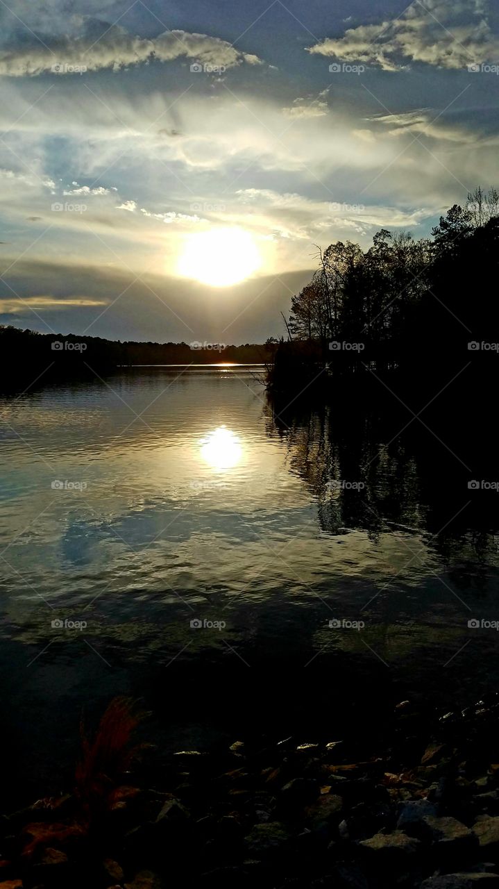 sun settinf over lake during a languid evening.