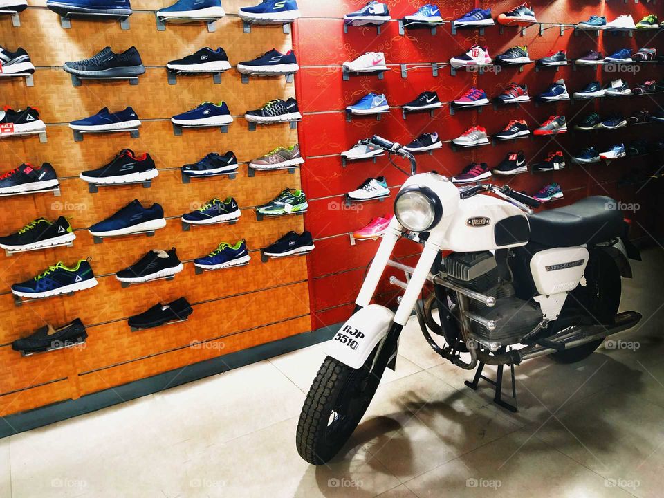 Vintage bike in a shoe store for display in Mumbai India.