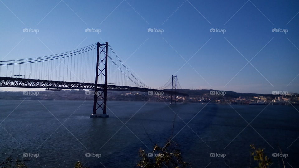 lisbon city 
this bridge is a symbol of the april revolution portuguese.
Is river is born in spain and drains in Portugal your name is Tejo river.