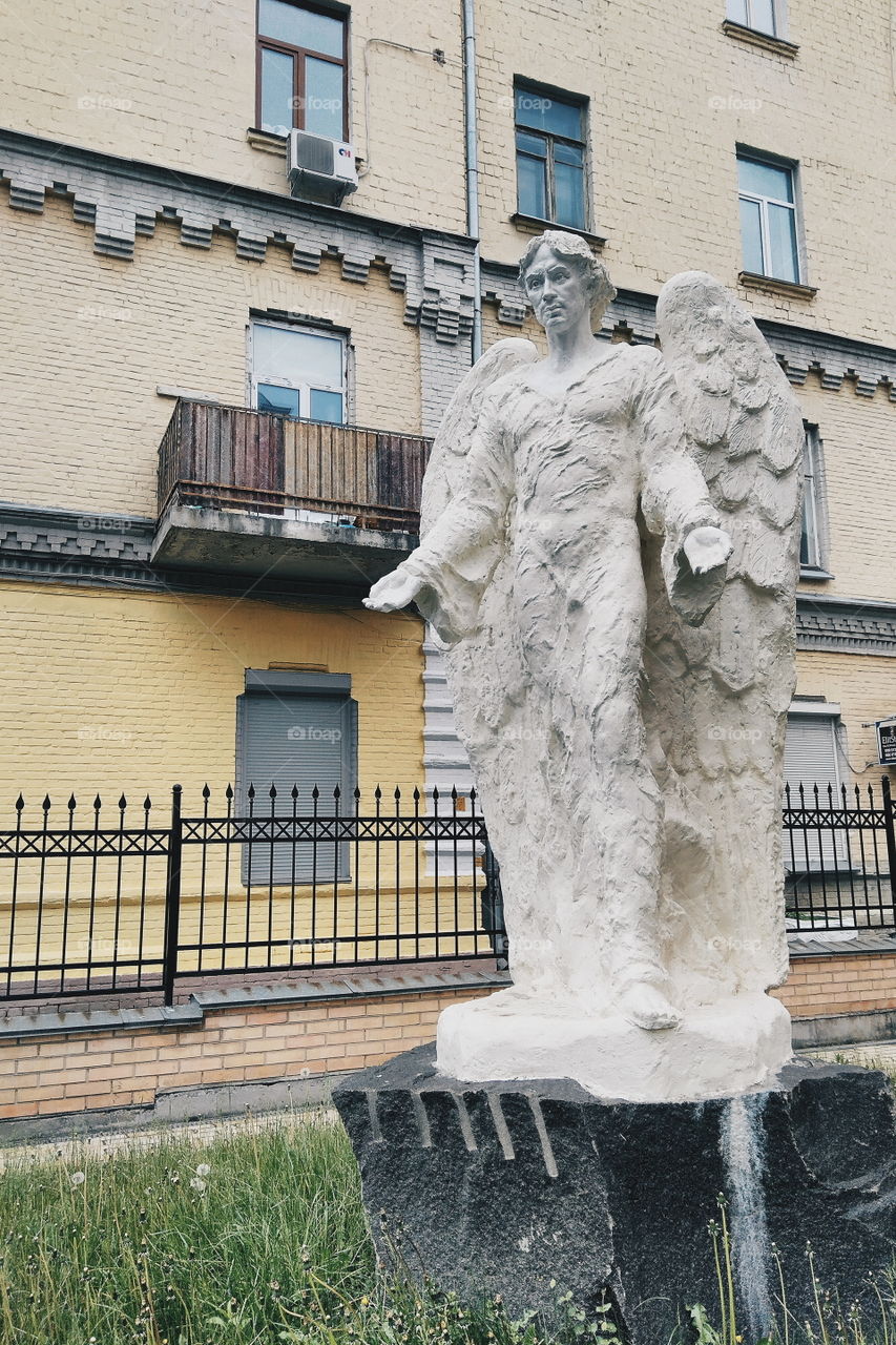 The statue stands near the house