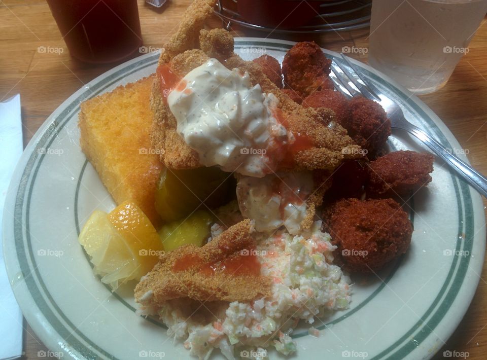 BBQ Platter. Fried Catfish with hush puppies, cornbread, pickles, and slaw. With a heavy dose of deliciousness