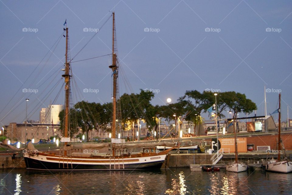 marina in the late afternoon with a full moon