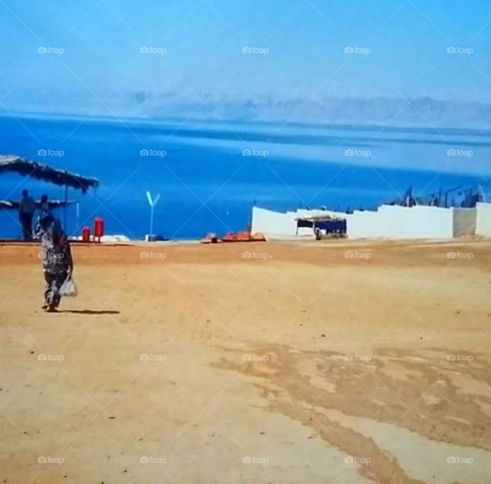 The blue sea and golden sand at Dead Sea, Jordan