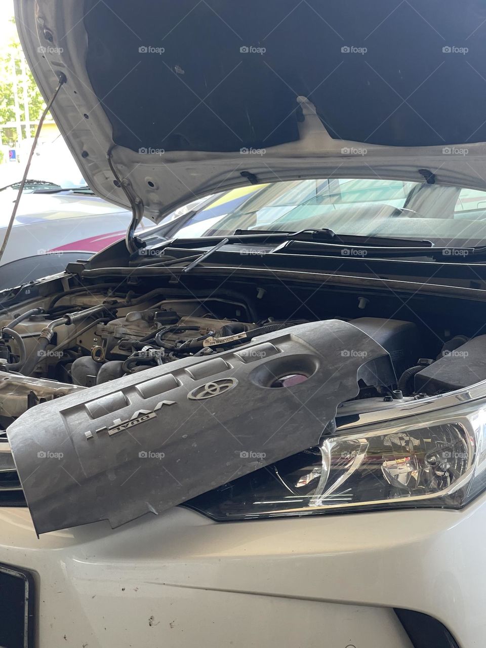 Opening the inner side of the car engine for fixing.