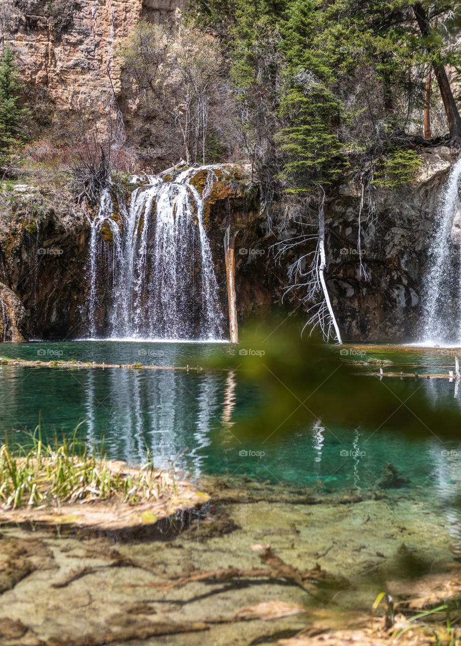 Beautiful crystal clear water flowing from a waterfall into a Colorado lake high in the mountains. 