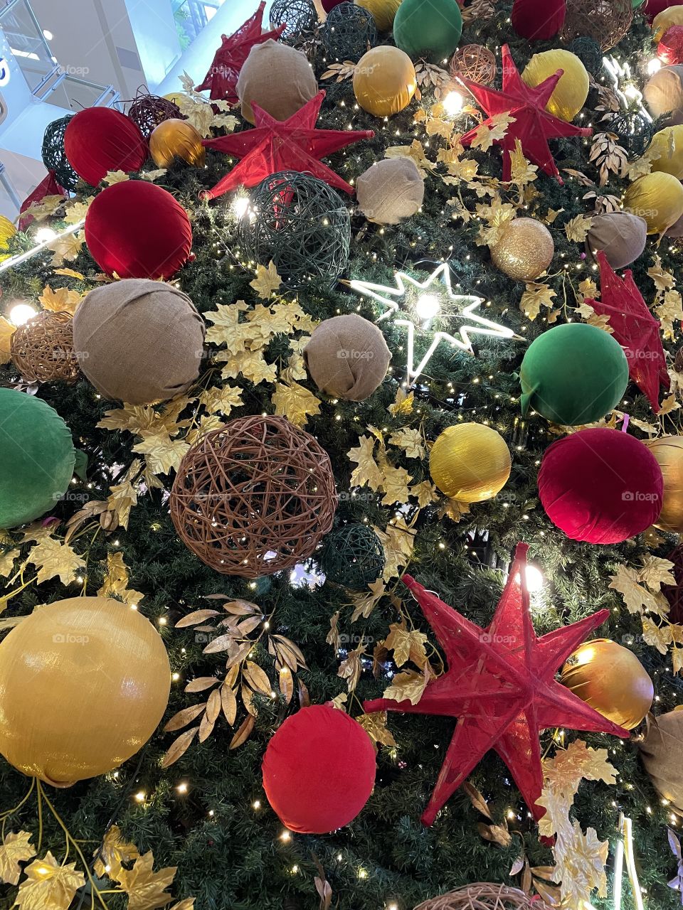 Christmas balls of various colors, materials and sizes adorned a Christmas tree