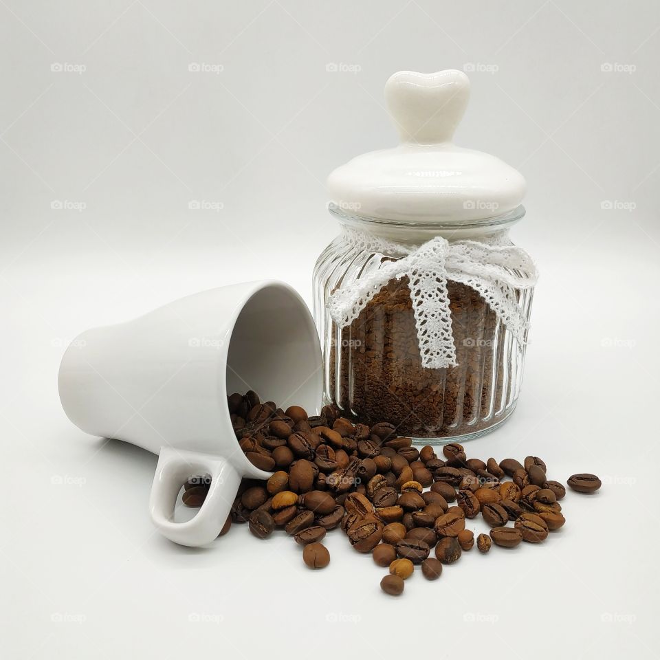 jar filled with coffee and roasted coffee beans on white background, mug