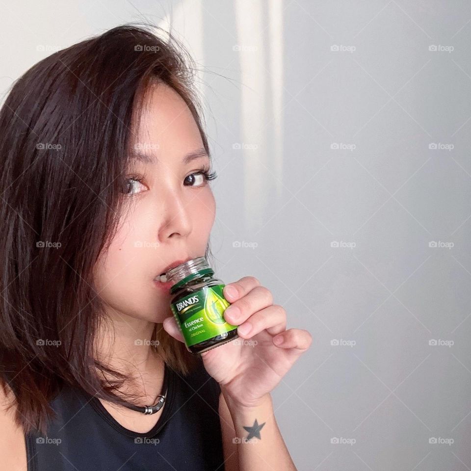 Asian woman with Chicken essence for energy of the day 