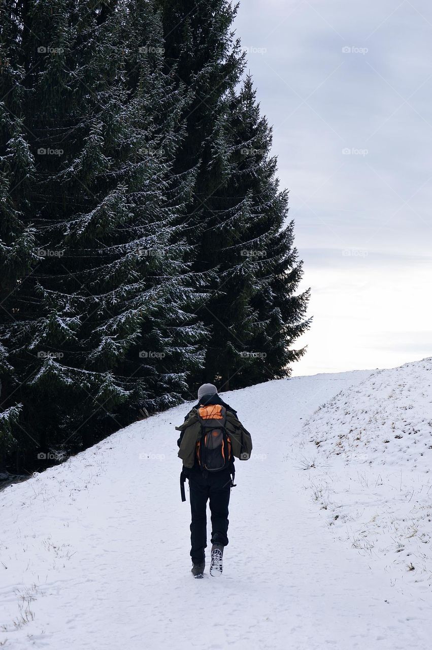 Photo of a young man hiking in the mountains 