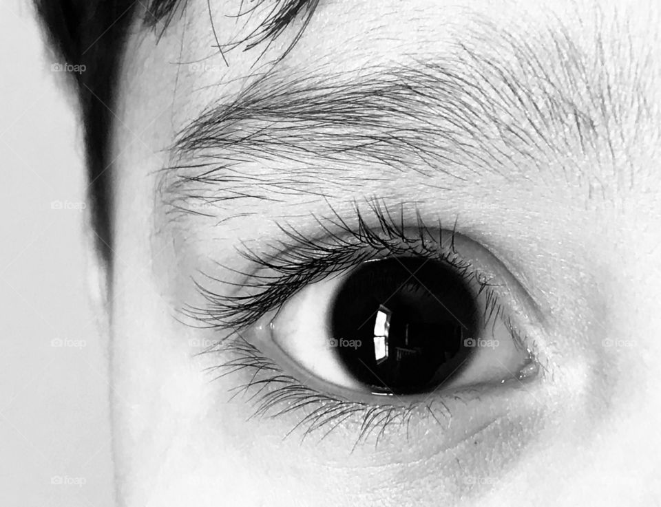 Closeup of a young child’s eye in black and white
