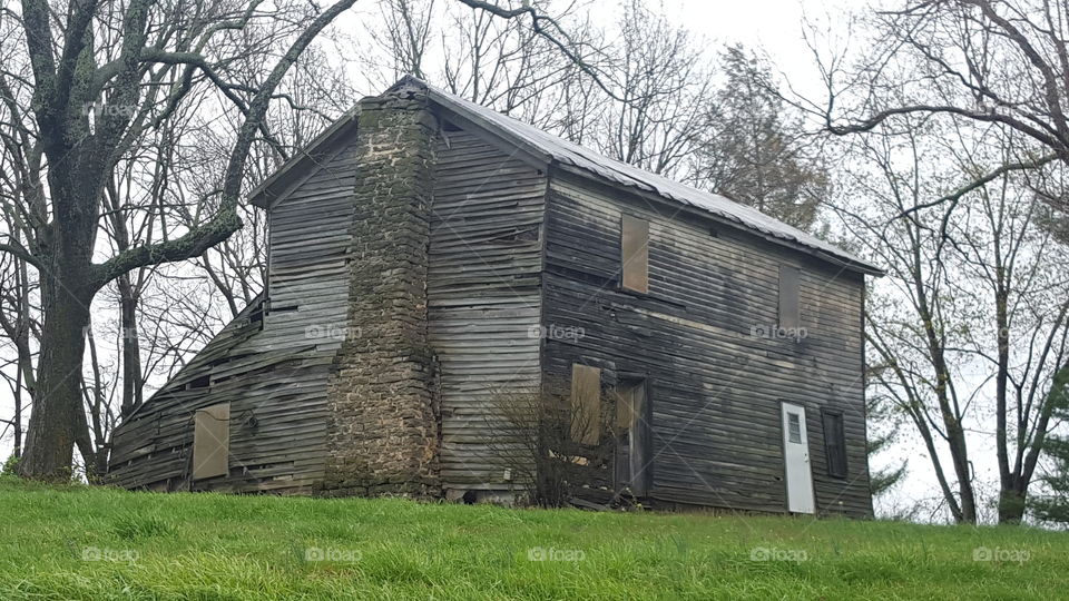 Old abandoned house on the grassy land