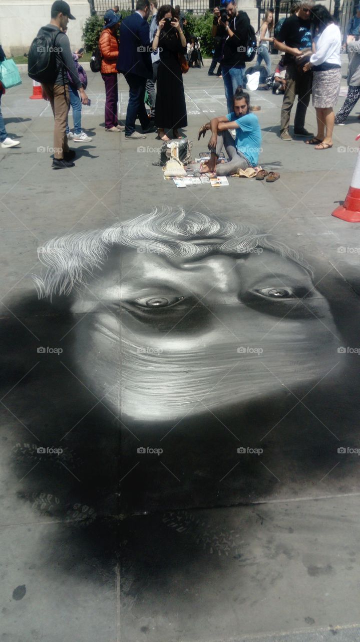 Chalk drawings attract tourists and passers by at Trafalgar square, London