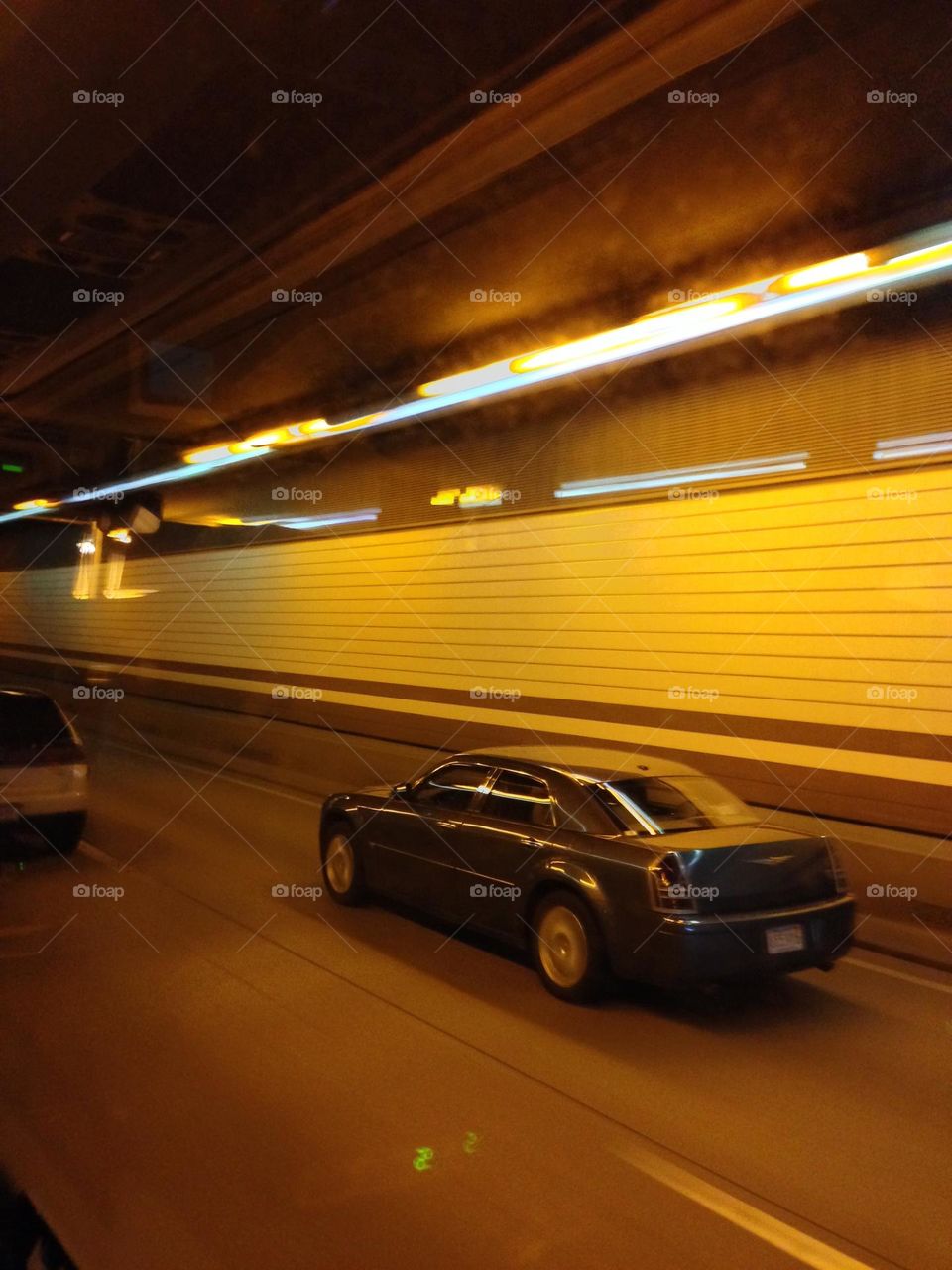 I was on a bus driving through the Callahan Tunnel in Boston, filming the passing cars speeding by.