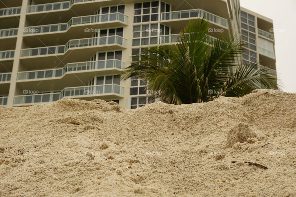 A building being caved in by the sand