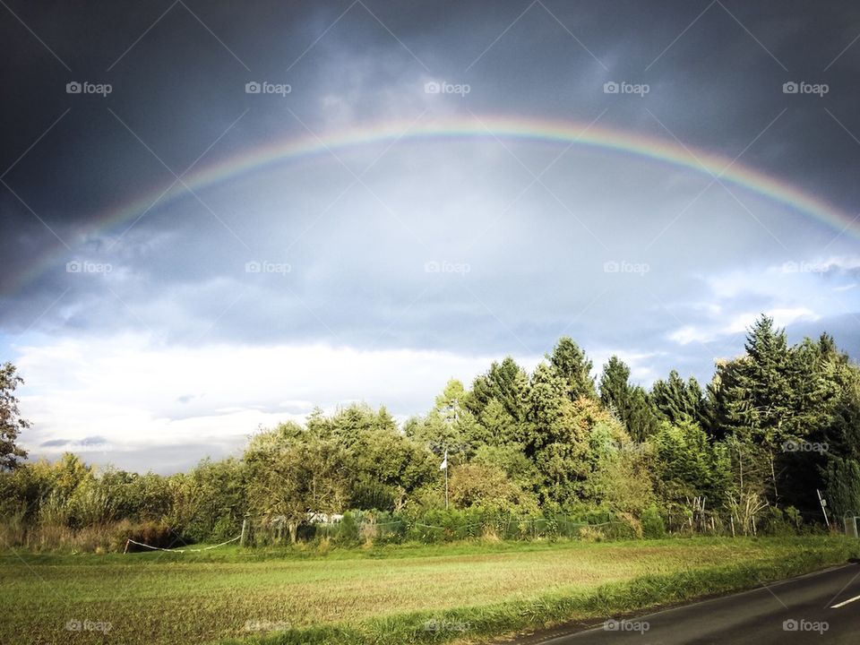 Rainbow fields in Germany on a cloudy sunset