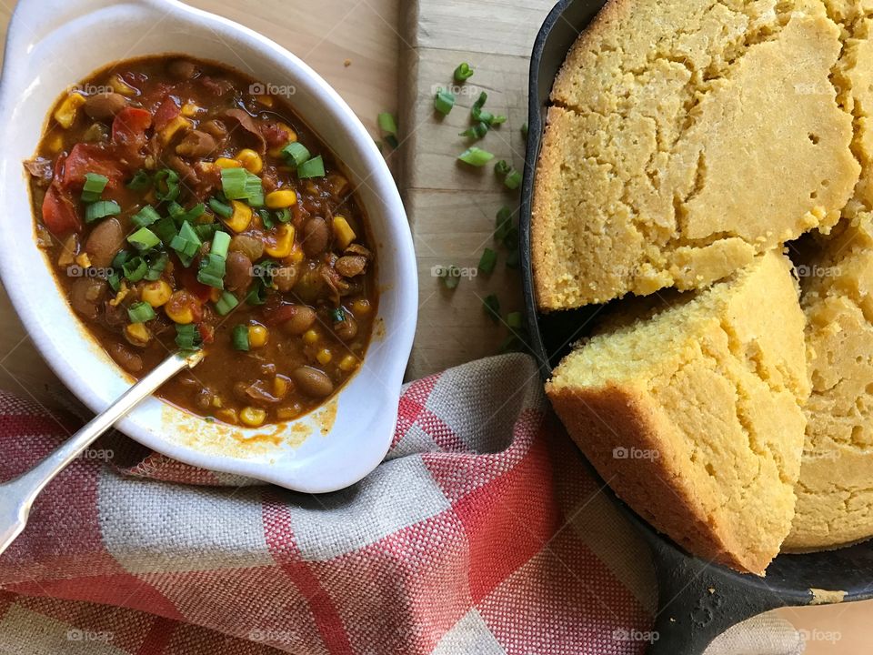 Bowl of chili with cornbread skillet