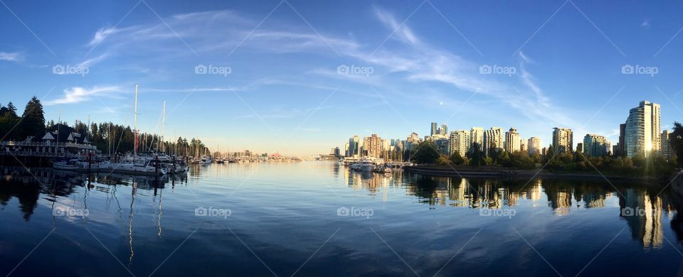 Beautiful view taken from Vancouver's Stanley Park in a hot and pleasant summer afternoon. From here you see the city's Central Business District with it's stunning buildings, Canada Place Events Centre, Coal Harbour and the Vancouver Rowing Club and it's Marina.
