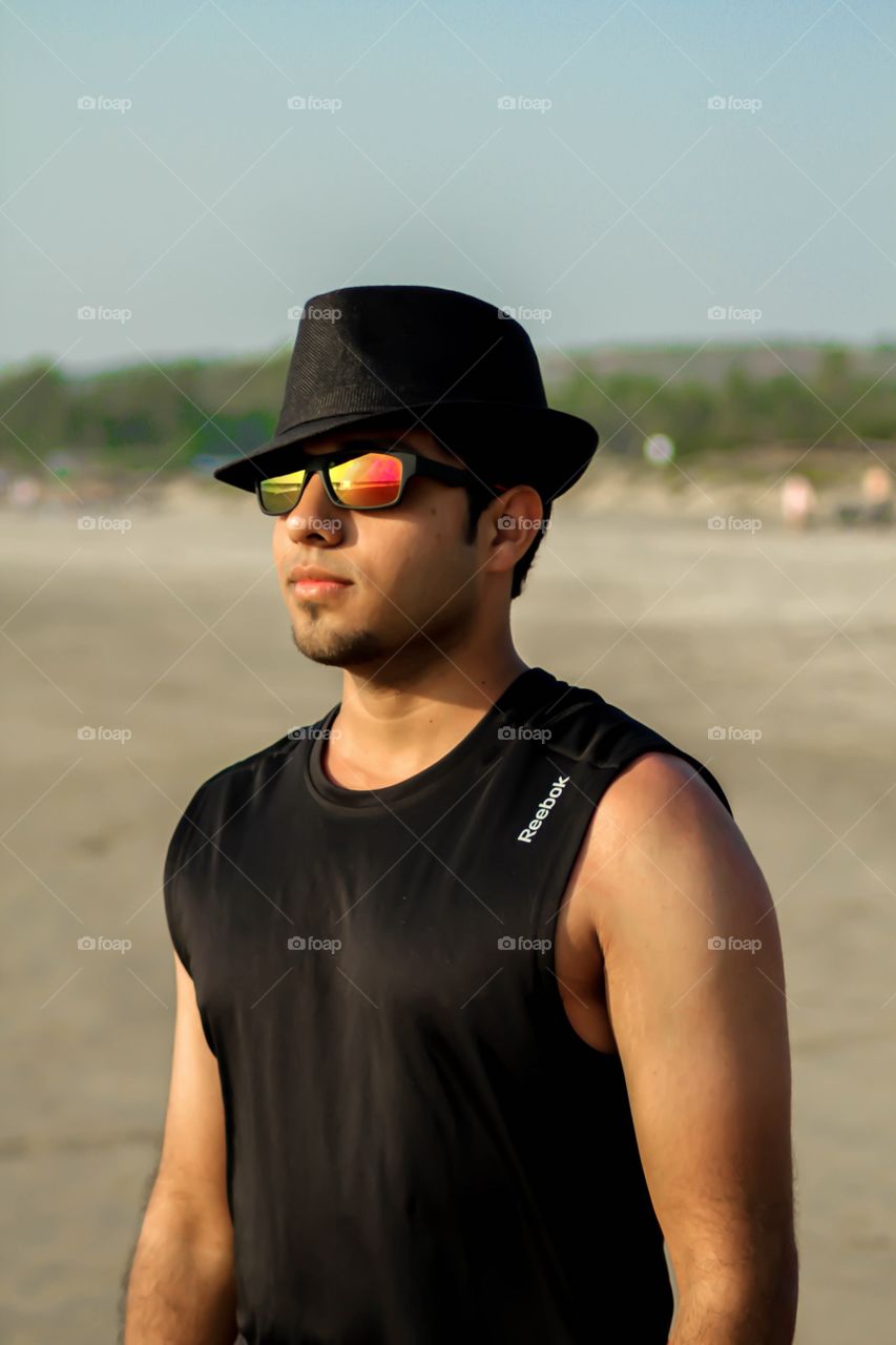 Indian man posing at beach
