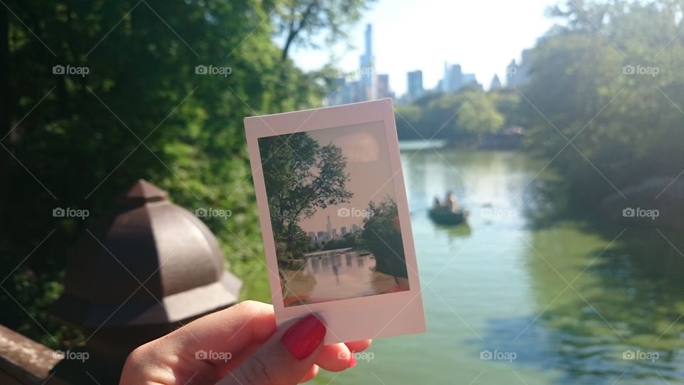 Hand holding an polaroid photo