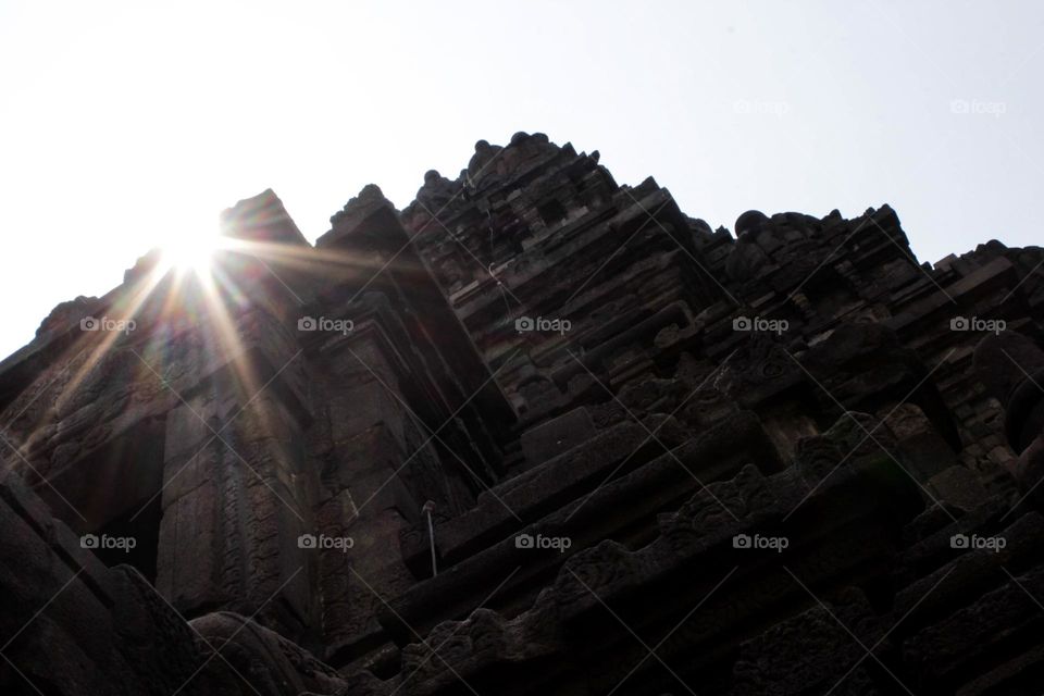 One of the temples in the Prambanan Temple Complex, with a stone relief on the wall of the temple which is part of the largest Hindu temple in Southeast Asia, Yogyakarta, Indonesia - June 23, 2023