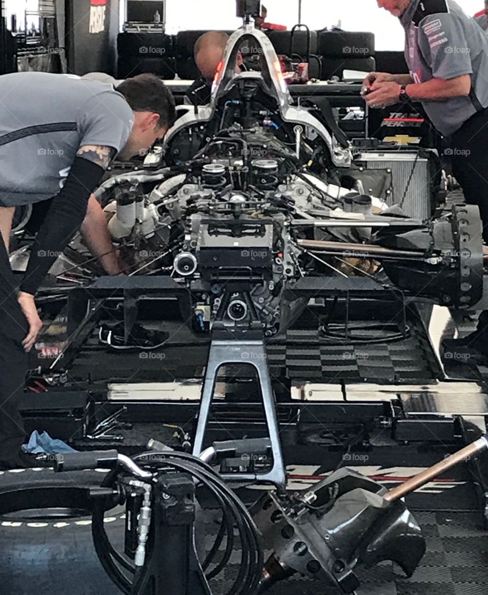 Mechanics working on a race car 