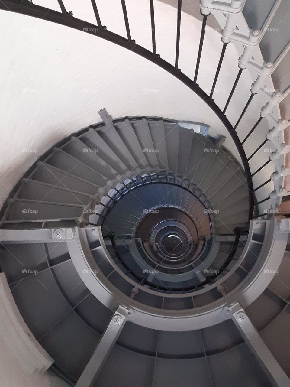 A photo of the interior of the Ponce Inlet Lighthouse spiral staircase taken from below.