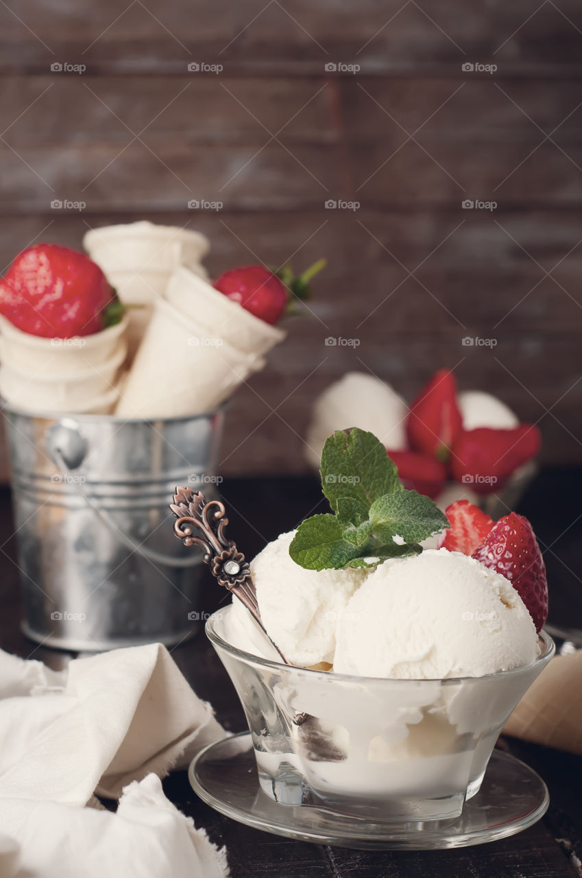 Cup of vanilla ice cream with basil leaf