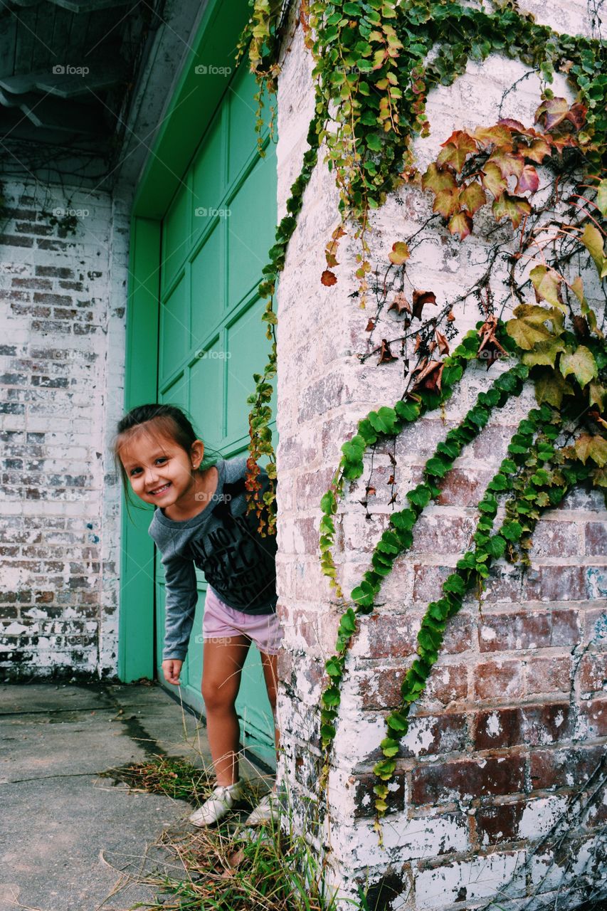 Girl standing near closed door