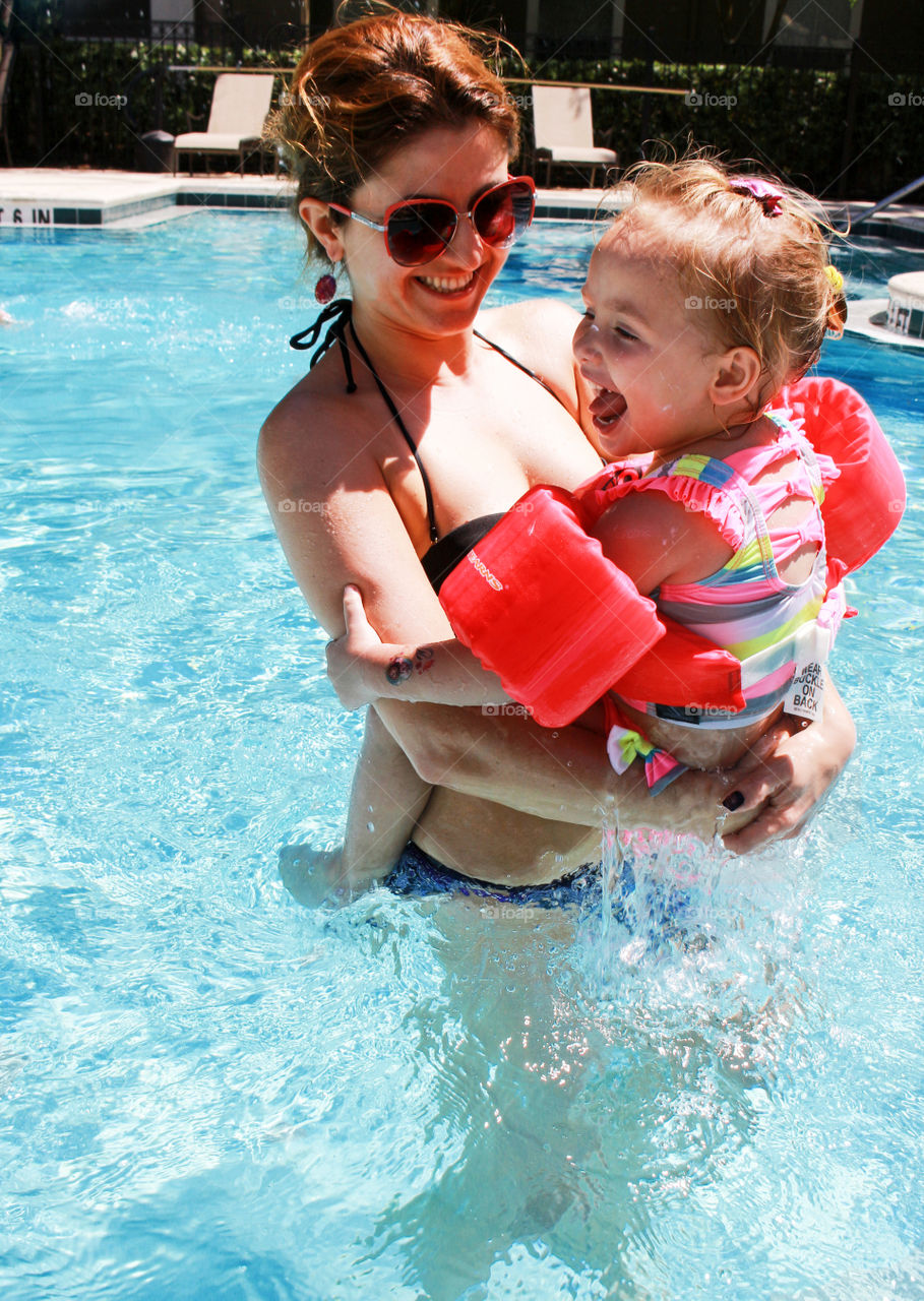 Mother and daughter in swimming pool