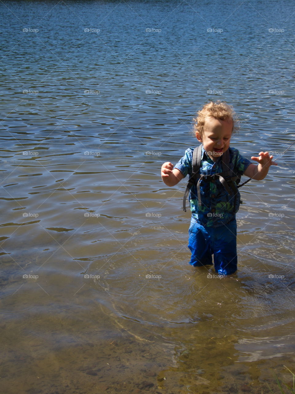 Little boy on summer vacation at high lake in Oregon forest 