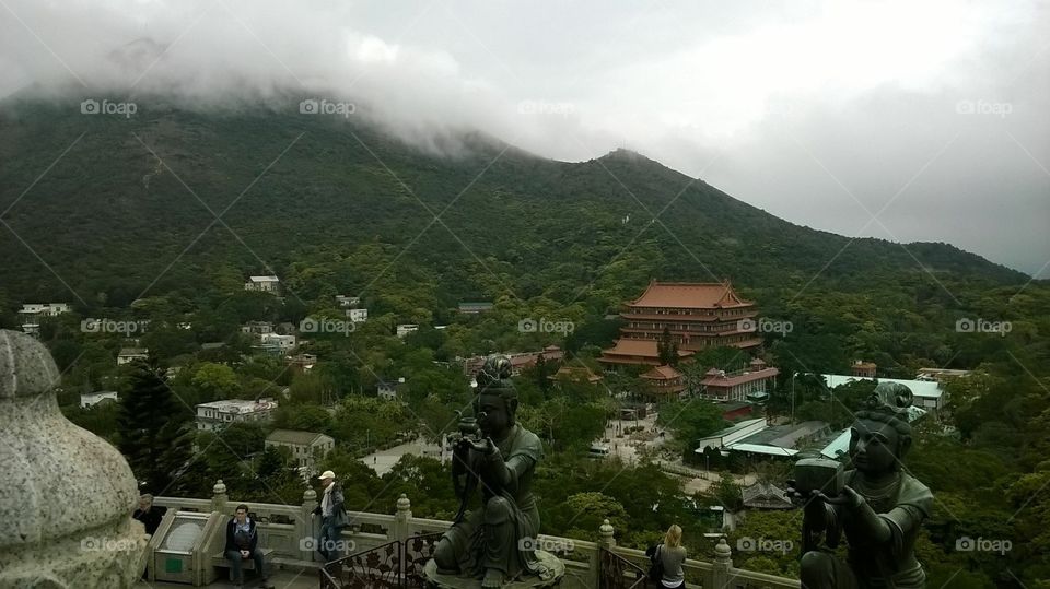 Buddhist temple, Lantau island, Hong Kong, China. Skyline with mountain clouds. 