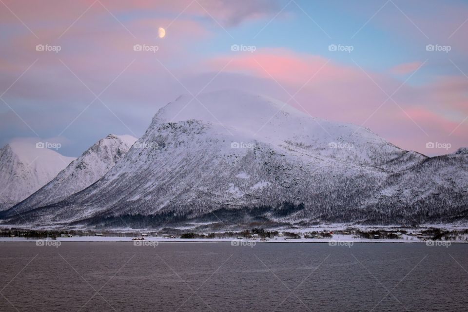 Polar nights in Norway along the beautiful coast by boat. Look at that moon! 