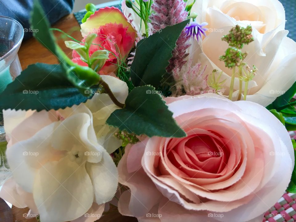 A colorful table decoration, the right hand leaf leads the eye to the centre of the pink rose.