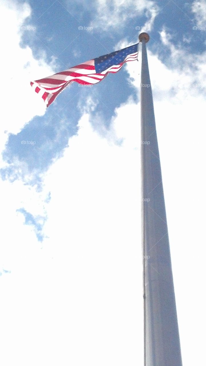 American Pride Up High. Underneath an American Flag outside a courthouse I take hopefully a breathtaking pic. of American's Pride waving high up