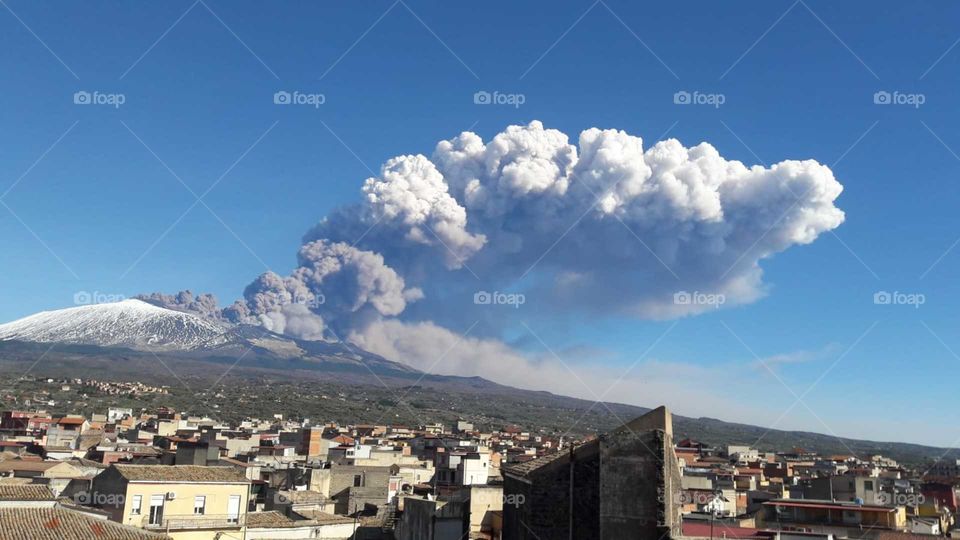 Etna volcano erupting and spewing ash, view from Adrano, Catania