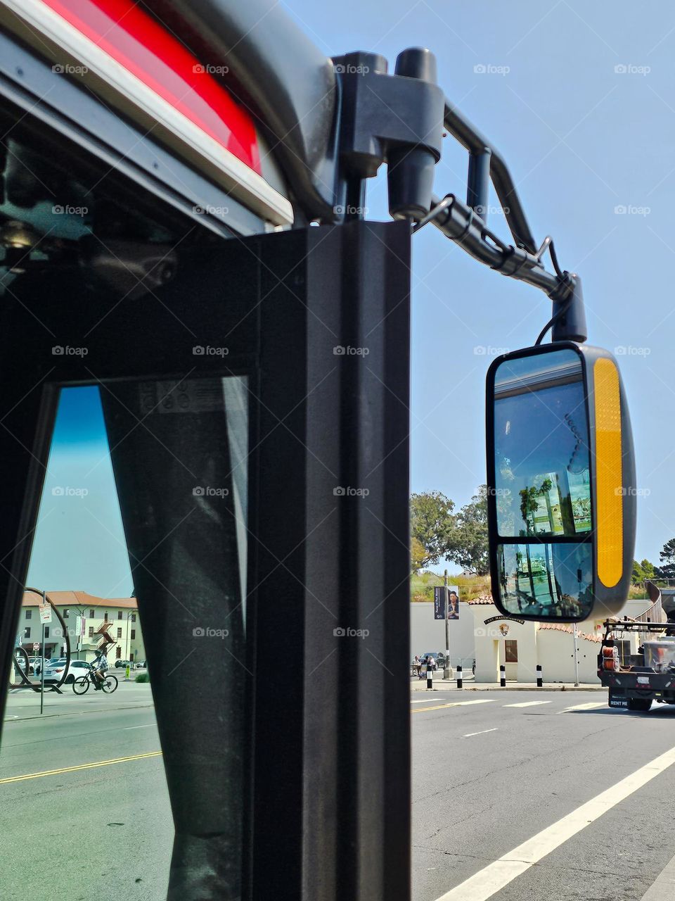 Reflection in the mirror of a Public transportation bus on the city streets of San Francisco California 