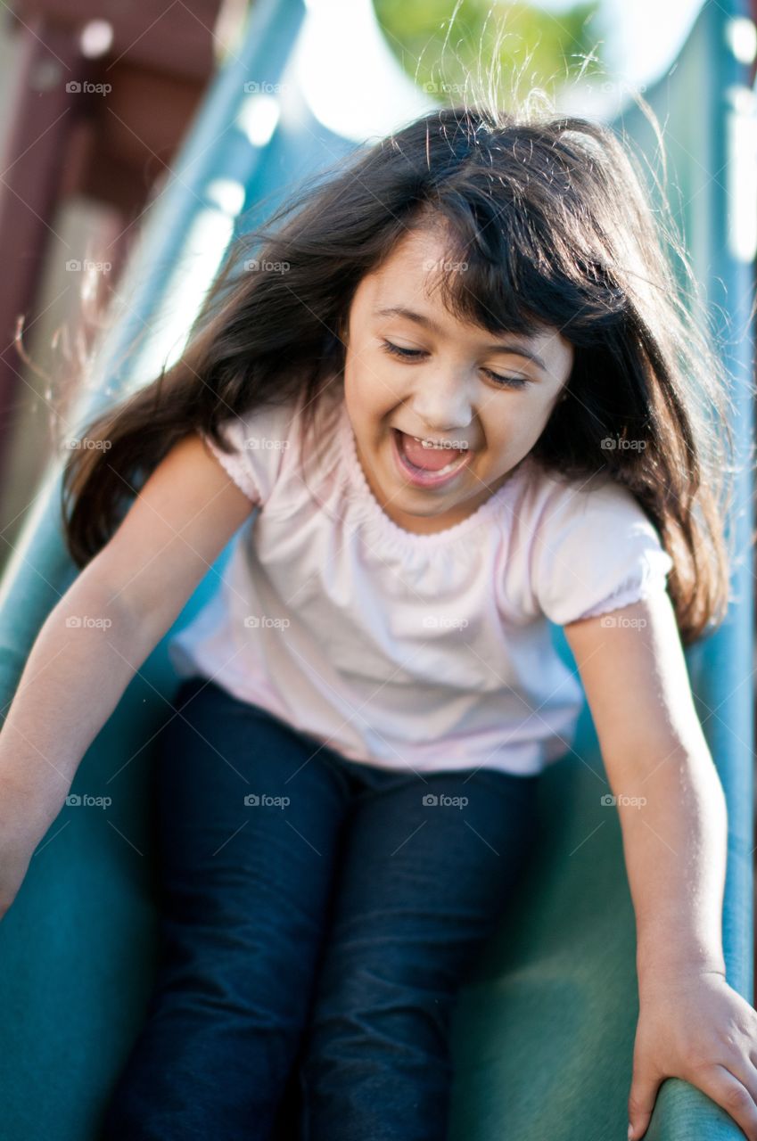 Girl playing on slide
