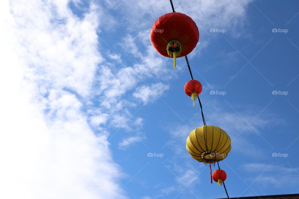 lanterns up in blue sky 