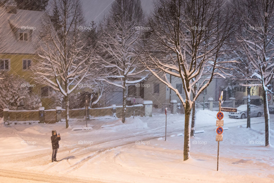 Guy taking photos of the snow 