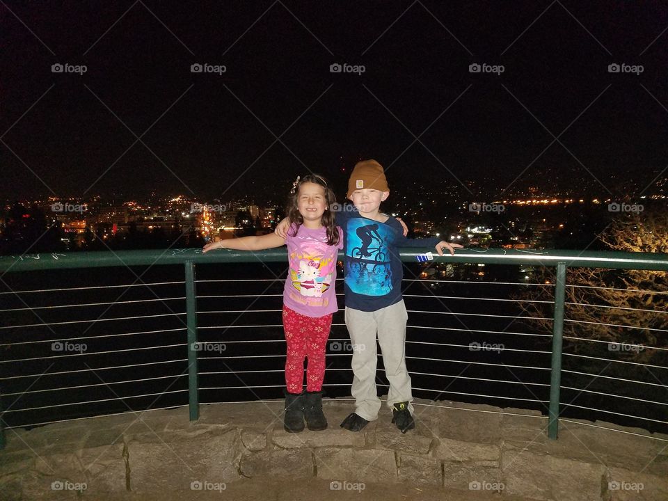 Kids above the city lights