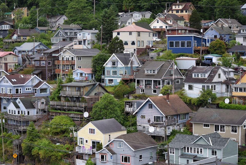 A picturesque Alaskan fishing village features hillside homes in many styles and colors.