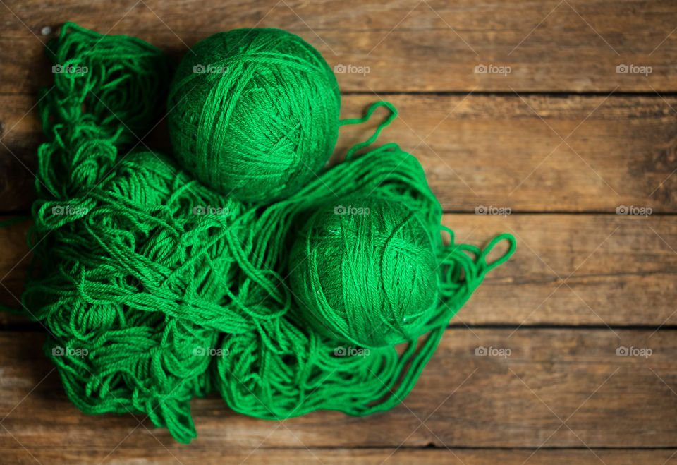 Ball of wool on wooden table