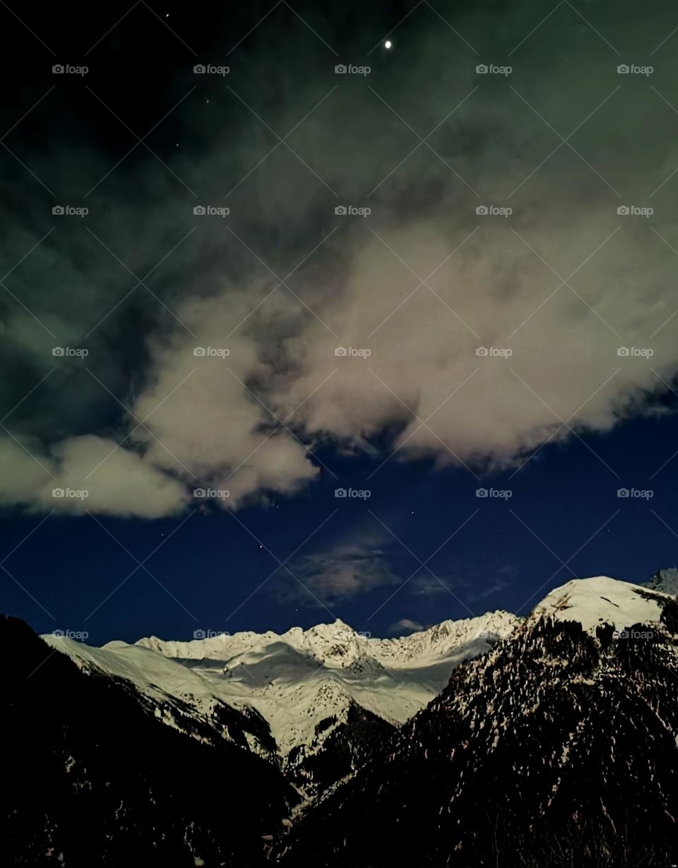 evening shades of clouds on mountain peaks