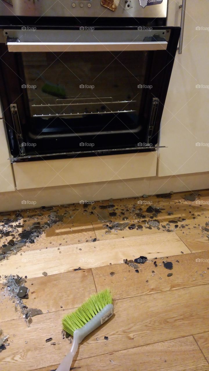 Home kitchen oven front door explosion. Shattered glass on kitchen floor.