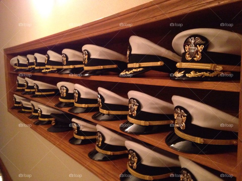 Military caps on shelf