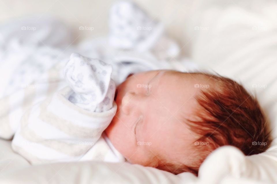 Baby kid sleeping on bed